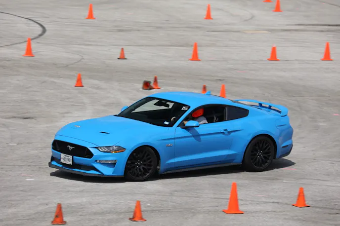 Grabber Blue S550 Mustang cornering at Autocross