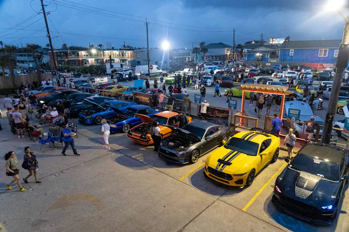 Kick off party from overhead showing a lot of mustangs in the parking lot