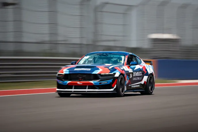 Multi color Mustang Dark Horse R on track