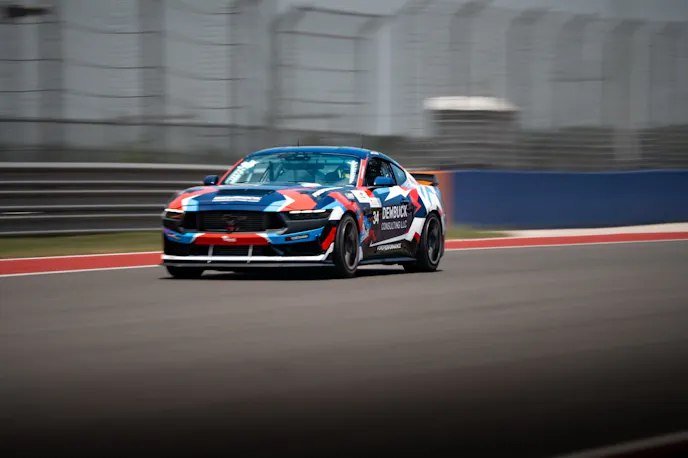 Multi color Mustang Dark Horse R on track