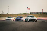 Three Mustang Dark Horse R's on track