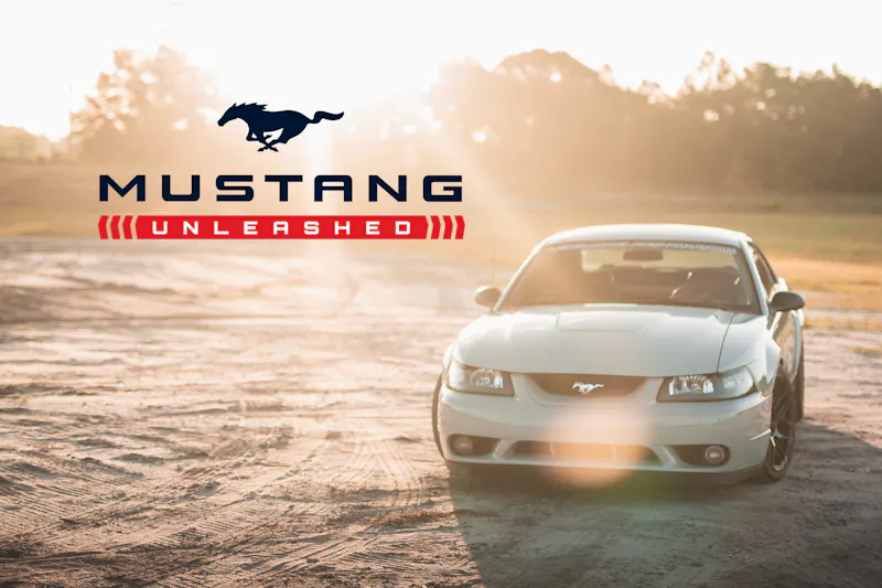 Gray Mustang in the sun with Mustang Unleashed logo